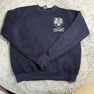 Oxford university crew neck with small bleach marks on wrist